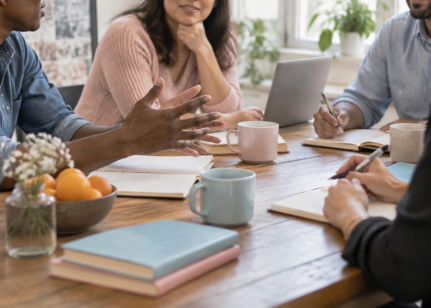 People gathered around a table in conversation